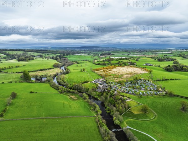 Farms over Ullswater Lake from drone, Pooley Bridge, Lake District National Park, Cumbria, England, United Kingdom
