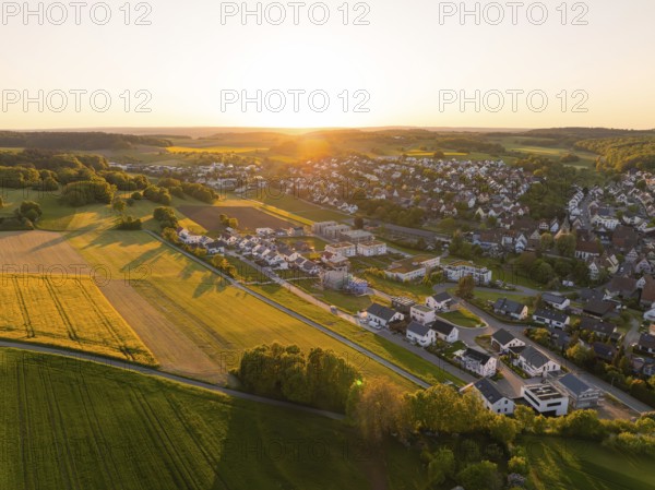 Aerial view of a village with fields and houses in the warm light of sunset, Gechingen, Black Forest, Germany