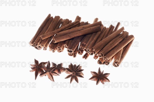 Cinnamon sticks and aniseed stars on a white background