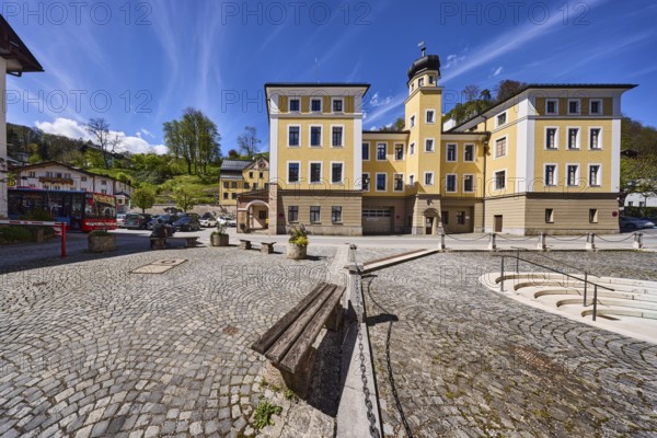 Town hall, historical building, bench, barrier chain, square, cobblestones, stairs, mountain landscape, hill, forest, trees, flower pots, blue sky, cumulus clouds, cirrostratus clouds, town hall square, Berchtesgaden, Upper Bavaria, district Berchtesgadener Land, Bavaria, Germany