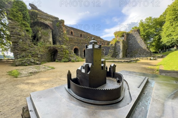 In front small metal model of the original fortress building of the ruins of the imperial palace of Emperor Frederick I Barbarossa, Kaiserswerth, Düsseldorf, North Rhine-Westphalia, Germany, built in the Middle Ages around 1184 on the present banks of the Rhine