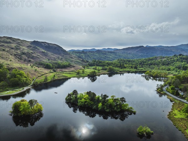 Farms and Mountains over road A591 from a drone, Grasmere Lake, Grasmere, Ambleside, Lake District, Westmorland, Cumbria, UK