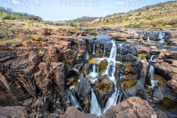 Waterfall on orange-coloured rock cliffs, long exposure, Blyde River, Bourke's Luck Potholes, Panorama Route, Mpumalanga, South Africa