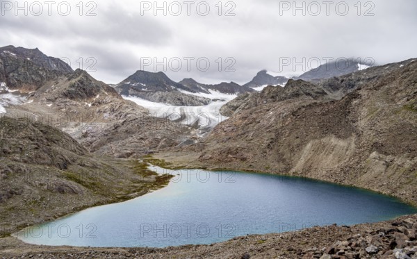 High mountain landscape with glacier tongue of the Übeltalferner and mountain lake Vogelhüttensee, Stubai Alps, South Tyrol, Italy