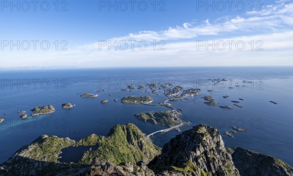 View of the sea and archipelago islands with the village of Henningsvær, Festvagstinden peak, coastal landscape, Lofoten, Nordland, Norway
