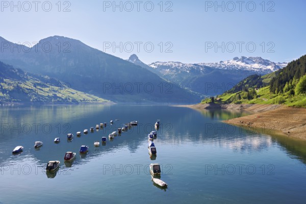 Motorboats moored at the reservoir, snow-covered Alps in the background, Lake Wägital, Canton Schwyz, Switzerland