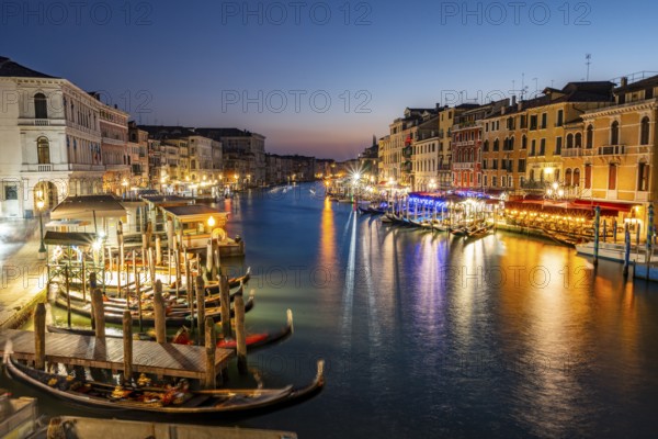 View of the Grand Canal at the blue hour, picturesque evening mood with illuminated palazzos on the canal, long exposure, view from the Rialto Bridge, Venice, Veneto, Italy