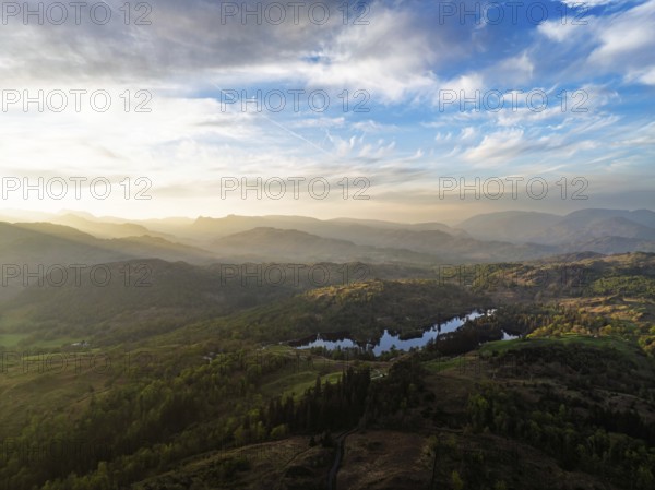 Sunset over Mountains and Coniston Water from drone, Lake District National Park, Cumbria, England, United Kingdom