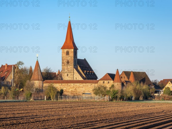 The medieval fortified church of St. George in the district of Kraftshof, Nuremberg, Middle Franconia, Bavaria, Germany