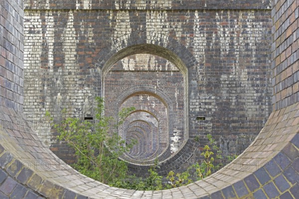 View through openings in piers of a railway viaduct, Stanway, Broadway, The Cotswolds, England, Great Britain