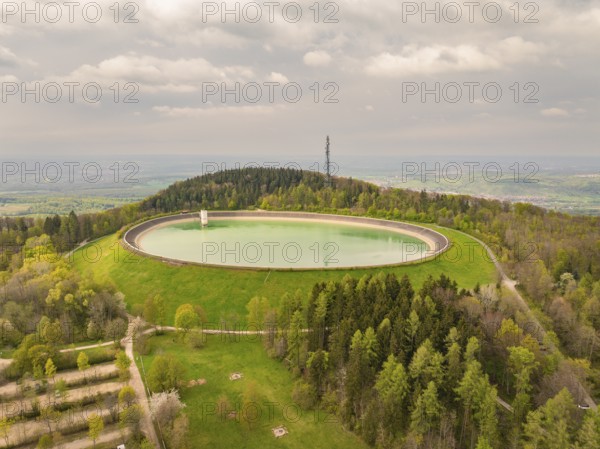 Upper reservoir Reservoir on a wooded hill with observation tower and green meadows, Glems reservoir, Swabian Alb, Germany