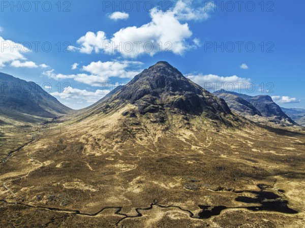 Buachaille Etive Beag and Three Sisters in Glencoe over Moors and Road A82 from a drone, Highlands, Scotland, United Kingdom