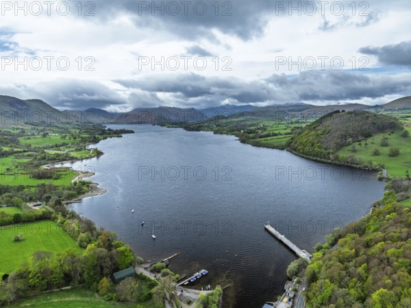 Farms and mountains over Ullswater Lake from drone, Pooley Bridge, Lake District National Park, Cumbria, England, United Kingdom