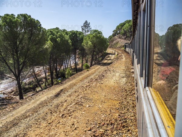 Views the train, touristic railroad line, Rio Tinto mining area, destroyed nature and remains of mining activities, Minas de Riotinto, Andalusia, Spain