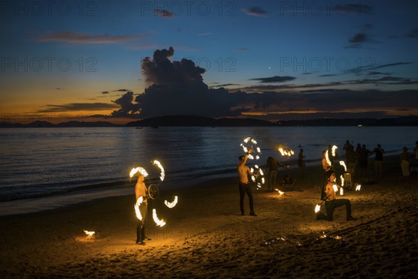 Fire show, jugglers with fire, Ao Nang Beach, sunset, Ao Nang, Krabi, Thailand
