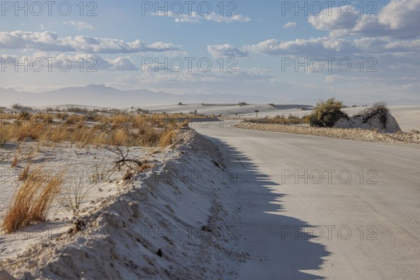 Road between sand dunes at White Sands National Park in Alamogordo, New Mexico, USA