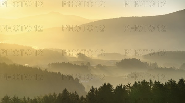 Landscape with forest, meadows and mountains around the town of Bad Kötzting, with a part of the Kaitersberg in the background on the right. In the morning at sunrise. District of Cham, Upper Palatinate, Bavarian Forest, Bavaria, Germany