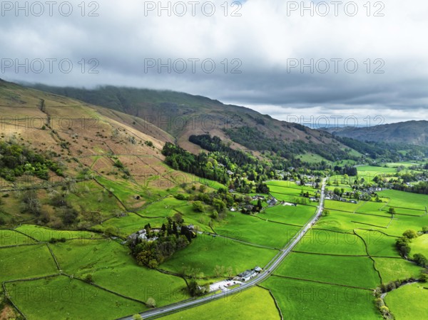 Farms and Mountains over road A591 from a drone, Grasmere Lake, Grasmere, Ambleside, Lake District, Westmorland, Cumbria, UK