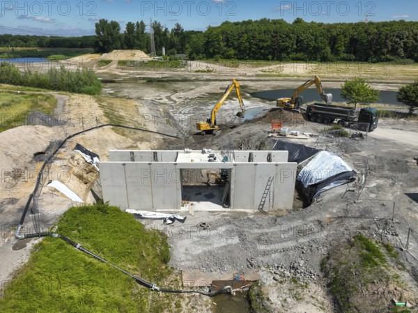 Dortmund, Castrop-Rauxel, North Rhine-Westphalia, Germany - River renaturalisation, renaturation of the Emscher, flood retention basin HRB Mengede. Heimanngraben intake in front, construction of a bridge over the ditch. A new floodplain landscape is being created at the Emscher-Auen farm, expansion of the area for flood protection during heavy rainfall and for biodiversity. The previously straightened Emscher is given curves again and can meander through its new floodplain. Following the construction of a parallel sewer, the Emscher has been completely free of sewage since 2022. The river was previously an open, above-ground combined sewer with rainwater and wastewater