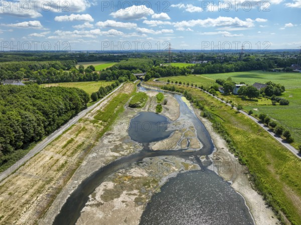 Dortmund, Castrop-Rauxel, North Rhine-Westphalia, Germany - River renaturalisation, renaturation of the Emscher, flood retention basin HRB Mengede. A new floodplain landscape is being created at the Emscher-Auen farm, expanding the area for flood protection during heavy rainfall and for biodiversity. The previously straightened Emscher is being given curves again and can meander through its new floodplain. Following the construction of a parallel sewer, the Emscher has been completely free of sewage since 2022. The river was previously an open, above-ground combined sewer with rainwater and wastewater