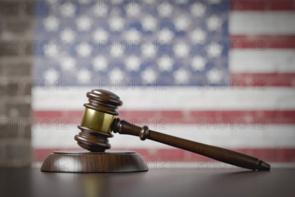 American flag on wall behind gavel resting on table