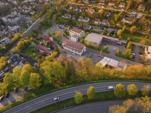 Town view with residential buildings, streets and autumnal trees in an evening atmosphere, Nagold, district of Calw, Germany