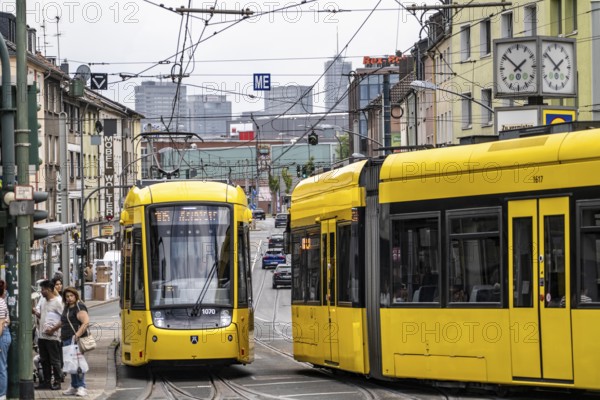 Ruhrbahn tram, on Altendorfer Straße, intersection Helenenstraße, in Essen-Altendorf, rush hour, traffic, skyline of the city centre of Essen, North Rhine-Westphalia, Germany