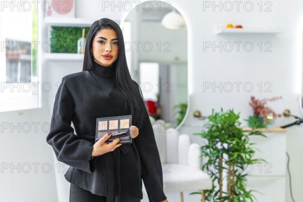 Professional makeup artist holding a palette and brush, offering makeup services in a modern and elegant beauty salon