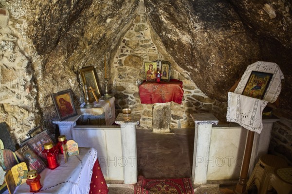 Legend, crab, shell fisherman, sacred interior of a small chapel with icons and candles in a rocky environment, mystical atmosphere, chapel, small church, Agia Kavouradena Monastery, Xirokambos, Leros, Dodecanese, Greek Islands, Greece