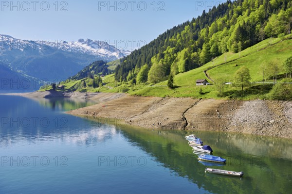 Motorboats moored at the reservoir, snow-covered Alps in the background, Lake Wägital, Canton Schwyz, Switzerland