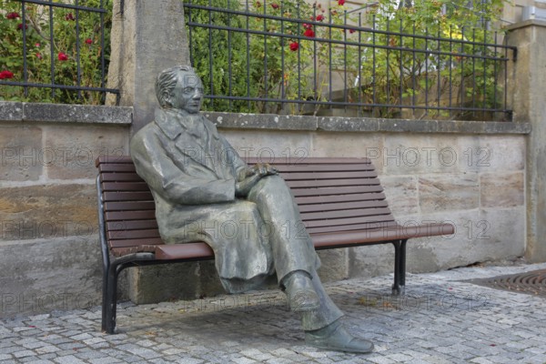 Johann Wolfgang von Goethe by Klaus Gutting sitting on the bench, bronze sculpture, looking, arms, monument, modern art, GoetheStadtMuseum, Amtshaus, market square, Ilmenau, Thuringian Forest, Thuringia, Germany
