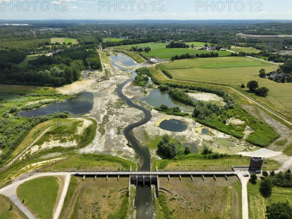 Dortmund, Castrop-Rauxel, North Rhine-Westphalia, Germany - River renaturalisation, renaturation of the Emscher, flood retention basin HRB Mengede. A new floodplain landscape is being created at the Emscher-Auen farm, expanding the area for flood protection during heavy rainfall and for biodiversity. The previously straightened Emscher is being given curves again and can meander through its new floodplain. Following the construction of a parallel sewer, the Emscher has been completely free of sewage since 2022. The river was previously an open, above-ground combined sewer with rainwater and wastewater