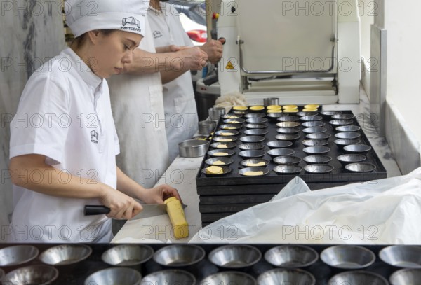Making Pastel de Nata cakes, Manteigaria coffee house cafe, Bolhao, city of Porto, Portugal