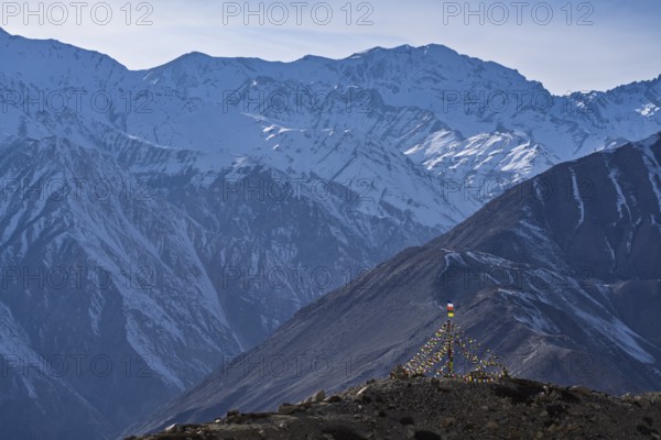 View of the Himalayan mountains, Buddhist prayer flags in the foreground, Himalayas, Hangrang, Himachal Pradesh, India