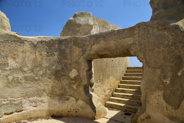 Entrance to ruined structure with stairs and blue sky, Lost Place, Air Defence Position, Aerophone, Parabolic Acoustic Mirror, Patella Mountain, WW2, west of Lakki, Leros, Dodecanese, Greek Islands, Greece