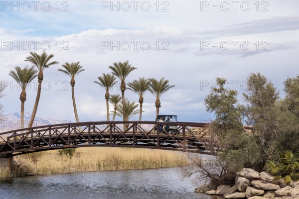 Golf cart crossing a golf cart bridge over an inlet of the Las Vegas Wash at Lake Las Vegas in Henderson, Nevada, USA