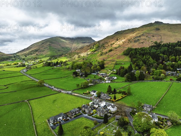 Farms and Mountains over road A591 from a drone, Grasmere Lake, Grasmere, Ambleside, Lake District, Westmorland, Cumbria, UK