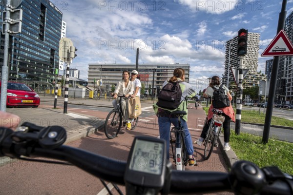 Cycle along the Jaarbeursplein, south of Utrecht Central, HBF, on the central cycle path in the city centre of Utrecht, lanes for pedestrians, cyclists and vehicles are separated, heavy cycle traffic, Netherlands