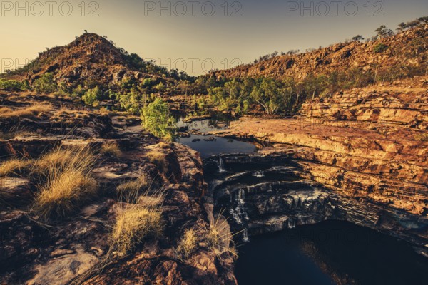Bell Gorge waterfall, a body of water in north-west Australia in the Kimberley. Sunrise in the outback, Australia