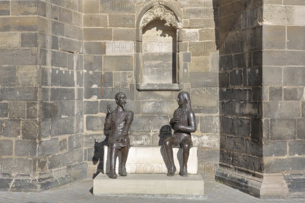 Sculpture Schütz-Novalis Bench by Steffen Ahrens and Grit Berkner 2022, composer Heinrich Schütz, writer Novalis Friedrich von Hardenberg, bench, monument, modern art, two, bronze sculptures, sitting, communication, interaction, pointing finger, listening, telling, talking, market square, Weißenfels, Saxony-Anhalt, Germany