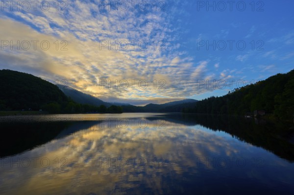 Beautiful lake view with impressive sky and calm water reflecting a peaceful sunrise, summer, Rursee, Obersee, Rurberg, Simmerath, Eifel National Park, Eifel, North Rhine-Westphalia, Germany