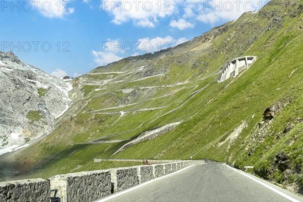 View of east ramp ascent to descent from Alpine pass Stelvio Stilfserjoch mountain road above tree line top right masonry of serpentine built into the steep slope, centre in the background many serpentines hairpin bends lead to pass summit of 2757 2758 metres high pass road mountain pass with tight bends hairpin bends Stilfser Joch Stilfserjoch Stelvio, Stilfs, South Tyrol, Alto Adige, Italy