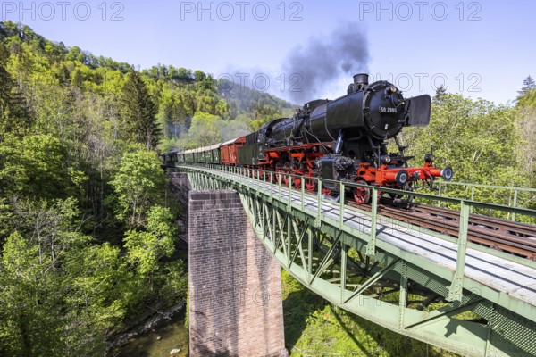Steam train of the Sauschwänzlebahn steam railway railway Steam locomotive on the Wutach bridge in Grimmelshofen, Germany