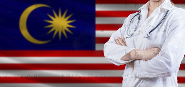 Doctor with crossed arms on Malaysia flag. Malaysia health and care concept. Female doctor on Malaysia flag