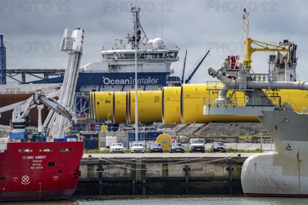 The seaport of Eemshaven, Julianahaven Basin, where the foundation structures, monopiles, for offshore wind farms are stored, which then support the actual wind turbines, the components are transported to the wind farms in the North Sea on large workboats and anchored to the seabed, where the wind turbines are then built, Eemshaven, Netherlands