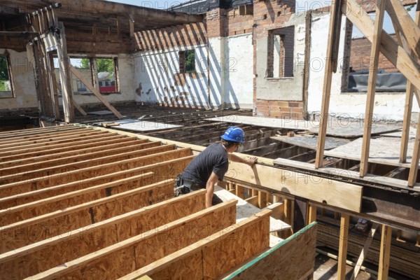 Detroit, Michigan - Austin Barr helps rehab a long-vacant and crumbling commercial building in the Morningside neighborhood. The project, called Ultreia, will contain first floor commercial space and apartments above