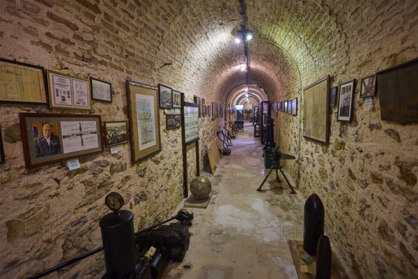 Long tunnel room with paintings and exhibits on the walls, War Museum, Military Museum, Tunnel Museum, Lakki, Leros, WW2, Dodecanese, Greek Islands, Greece