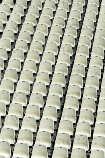Empty stadium seats arranged in neat rows highlight the readiness for an upcoming sports event or concert