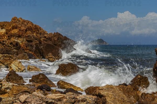Rugged rocks and foaming spray on Topinetti beach, near Rio Marina, Elba Island, Tuscan Archipelago National Park, Tuscany, Italy