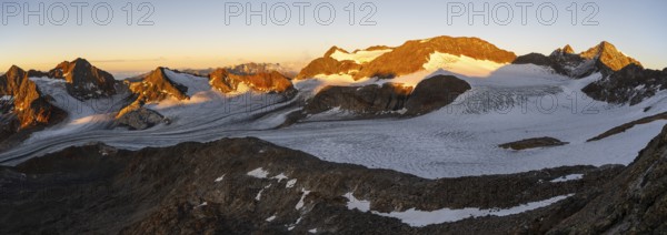 Picturesque high mountain landscape at sunrise with alpenglow, blue glacial lakes, glaciers and rocky mountain peaks in the morning light, view at Becher of mountain peaks Königshofspitz and Sonklarspitze and Schwarzwandspitz with glacier Übeltalferner, Stubai Alps, South Tyrol, Italy